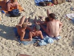 Group of guys having sex on the beach