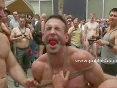 Procession of gay men take their sex slave spanking him in public