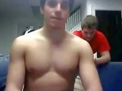 Straight hockey player giving a webcam show with team friends looking on