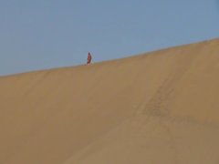 man naked on huge dunes