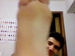 Straight brazilian soccer player showing his feet on cam