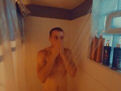 Redhead amateur edges his partially hard cock and moans for you after taking a shower